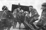 British howitzer team wearing gas masks